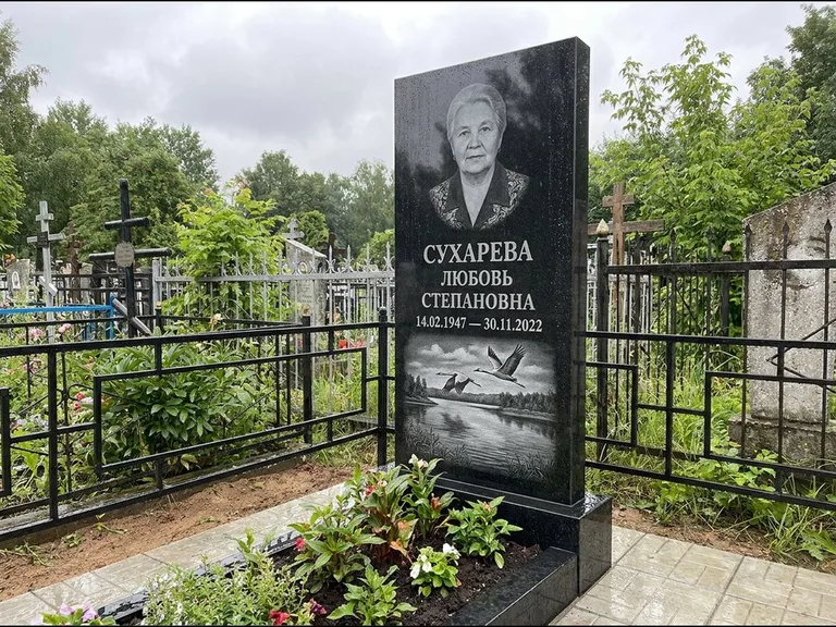 Памятник с гравировкой журавлей — гравировка пары журавлей над гладью озера в нижней части, работа «Сухарева» в Саратове